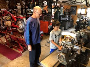 Albert patiently showing Jake how a lathe works.